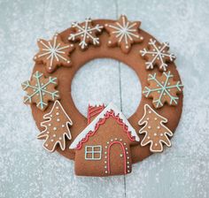 a gingerbread christmas wreath with snowflakes and trees