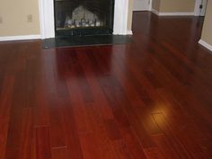 a living room with hard wood floors and a fire place in the fireplace mantel