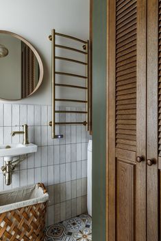 a bathroom with a sink, mirror and towel rack