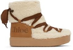 Ankle-high shearling and buffed calfskin boots in off-white and tan. · Lace-up closure in brown · Tonal logo-embossed buffed calfskin trim at heel · Tonal buffed calfskin lining · Tonal treaded rubber sole · Antiqued gold-tone hardware Supplier color: Natural | See by Chloe Off-White Charlee Ankle Boots Chloe Betty Shearling Boots, Luxury Shearling Boots With Round Toe, Brown Boots White Fur, Shearling Lace-up Winter Boots, Luxury Shearling Boots With Faux Fur Trim, Chloe Clothing, See By Chloe, Ugg Boots, Winter Boot