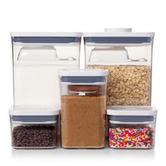 three storage containers filled with cereal, cereal and other food items on a white background