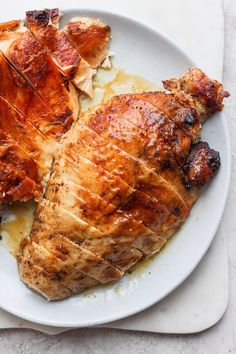 two pieces of chicken on a white plate