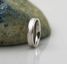 a wedding ring sitting on top of a rock