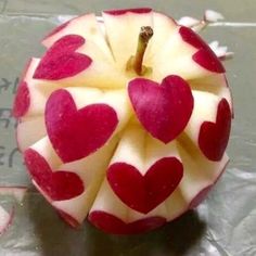 an apple with hearts cut out of it