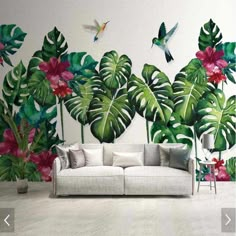 a living room filled with furniture and wallpaper covered in tropical leaves, flowers and birds