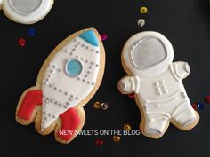 two decorated cookies sitting next to each other