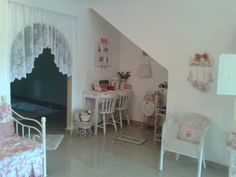 a room with white furniture and pink walls