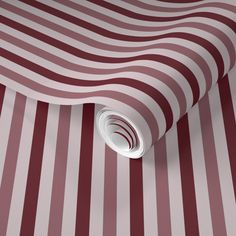 a red and white striped wallpaper with a circular hole in the center on top