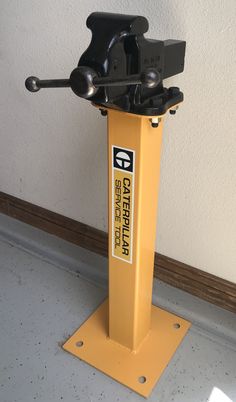 a yellow stand with two black handles on it