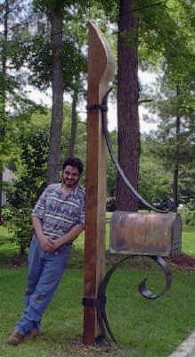 a man standing next to a wooden pole