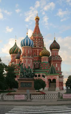 a large building with many domes on it's sides and a statue in front