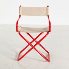 a red and white chair with a beige seat