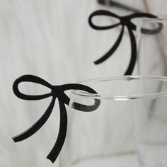 two clear vases with black bows on them