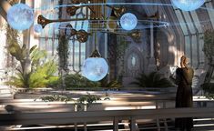 a woman standing in front of a church with lots of lights hanging from the ceiling