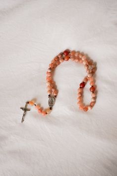 “It is love alone that gives worth to all things.” // Saint Teresa of Avila Introducing handcrafted Rosaries, prayerfully created by Blessed is She and inspired by great Saints. Carefully designed to be durable and beautiful, we’re honored to bring this prayer tool into your hands. This Rosary, inspired by Saint Teresa of Avila, features fiery, multicolored oranges and reds inspired by her passion for Jesus. Each bead of this Rosary is meticulously crafted from high-quality matte stones, creatin Handmade Spiritual Healing Rosary, Handmade Spiritual Rosary, St Teresa Of Avila, Saint Teresa Of Avila, Teresa Of Avila, St Teresa, Church Candles, Life Of Christ, Saint Teresa