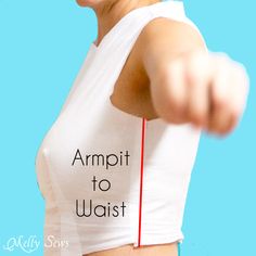 a woman in white shirt pointing at the camera with armpit to waist sign on it