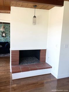 an empty living room with a fireplace in it