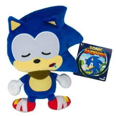 sonic the hedge plush toy next to a book