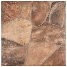 a close up view of a stone floor with brown and tan colors on the tiles