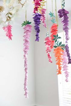 paper flowers hanging from the ceiling in a room