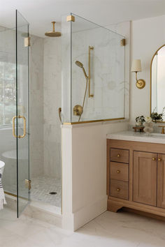 a bathroom with a walk in shower next to a sink