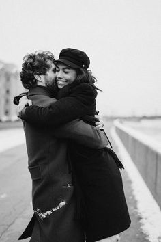 black and white photo of two people hugging each other