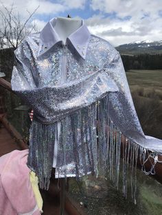 Girls silver/white high shine with   silver sequines fringe added to sleeve .  fringe can go over sleeve cap or underarm. this one has white collar but can be any color, choice of design on collar.   Hand wash, no heat lay flat to dry,   don't leave soak with the fringe all seams are surged  I can add fringe to all shirts for an extra 25$,  this one comes with it but can order just the shirt too.    I have several color of fringe, not all are sequines GIRLS  LARGE--MEASURMENTS BELOW      MEASURE Western Pleasure Shirt, Western Show Shirts, Fringe Shirt, Western Pleasure, Cowgirl Shirts, Don't Leave, No Heat, White Collar, Girl Top