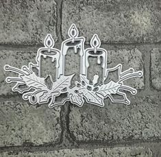 a metal candle sticker sitting on top of a brick wall