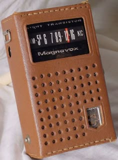 an old style radio sitting on top of a bed