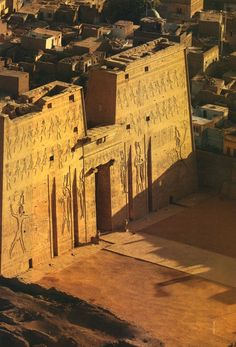 an aerial view of the ancient egyptian city of edfu, with its walls painted yellow