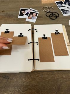 an open book with pictures and photos on it, sitting on a table next to scissors