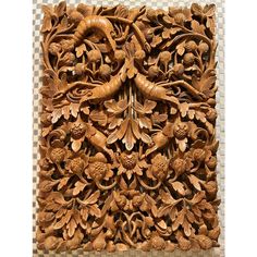 an intricate carved wood panel with flowers and leaves