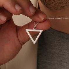 Discover the sleek and modern style of our Triangle Men's Silver Necklace, designed for those who appreciate minimalist yet striking jewelry. This geometric pendant, crafted from high-quality sterling silver, offers a bold statement piece that complements any outfit. Perfect for everyday wear or as a thoughtful gift for the special man in your life. Geometric triangle pendant design for a modern, minimalist look Crafted from premium sterling silver for lasting shine and durability Versatile piec Silver Jewelry For Men, Pendant Minimalist, Mens Silver Necklace, Triangle Pendant, Jewelry For Men, Geometric Triangle, Perfect Gift For Him, Geometric Pendant, Pendant Design