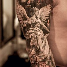 the back of a man's arm with an angel tattoo on it