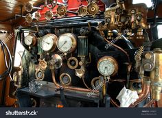 there are many clocks and gauges on the wall in this train car that is very old