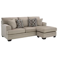 a beige sectional couch with pillows on it