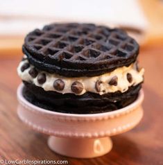 two chocolate chip ice cream sandwiches are stacked on top of each other in a plate