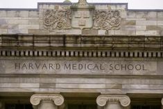 the harvard medical school building is shown in this photo, with columns on either side