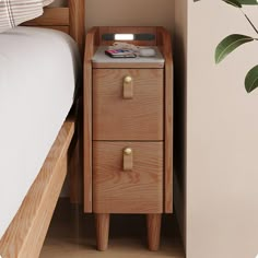 a wooden night stand with two drawers next to a bed and potted plant in the corner