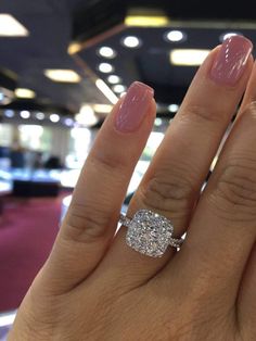 a woman's hand with a diamond ring on it