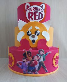 the cake is decorated with an image of children's characters on it and has been cut out to look like a bear