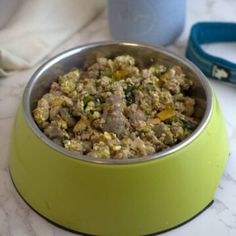 a yellow bowl filled with food on top of a table