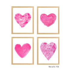 four pink heart paintings on white paper with gold trimmings, framed in wooden frames