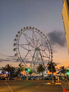 a ferris wheel sitting in the middle of a parking lot