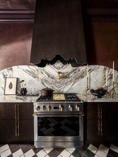 a stove top oven sitting inside of a kitchen next to a wall mounted range hood