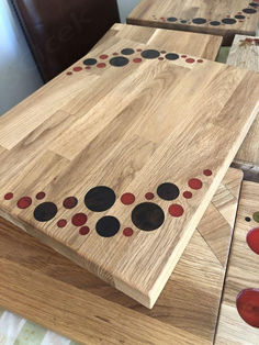 several pieces of wood with dots on them sitting on a table top next to a chair