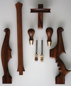 several pieces of wood are arranged on the wall, including two handles and one door handle