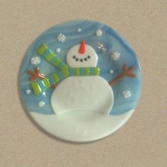 a ceramic snowman ornament on a white surface