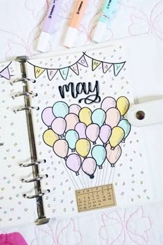 an open planner with balloons on it