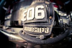 a fireman's hat sitting on top of a motorcycle helmet with the number sixty eight below it